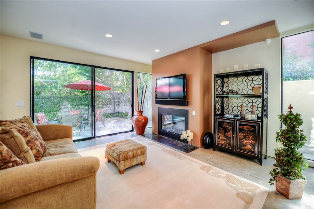 2831 Ridge Drive Laguna Beach, CA 92651 - Photo 23 of 49 a living room with furniture a flat screen tv and a large window