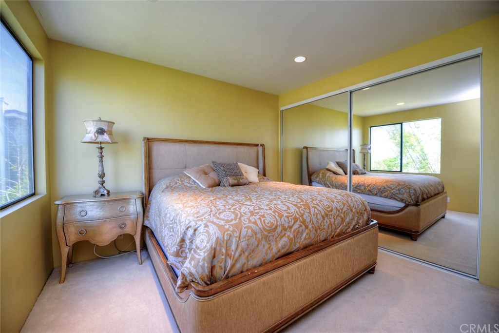 2831 Ridge Drive Laguna Beach, CA 92651 - Photo 28 of 49 a spacious bedroom with a bed and wooden floor