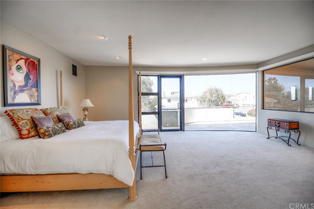 2831 Ridge Drive Laguna Beach, CA 92651 - Photo 33 of 49 a bedroom with a large bed and a large window