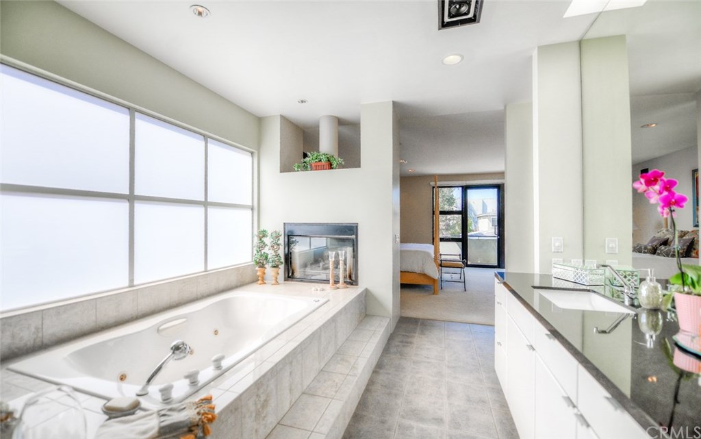2831 Ridge Drive Laguna Beach, CA 92651 - Photo 40 of 49 a spacious en suite bathroom with a tub double vanity and windows
