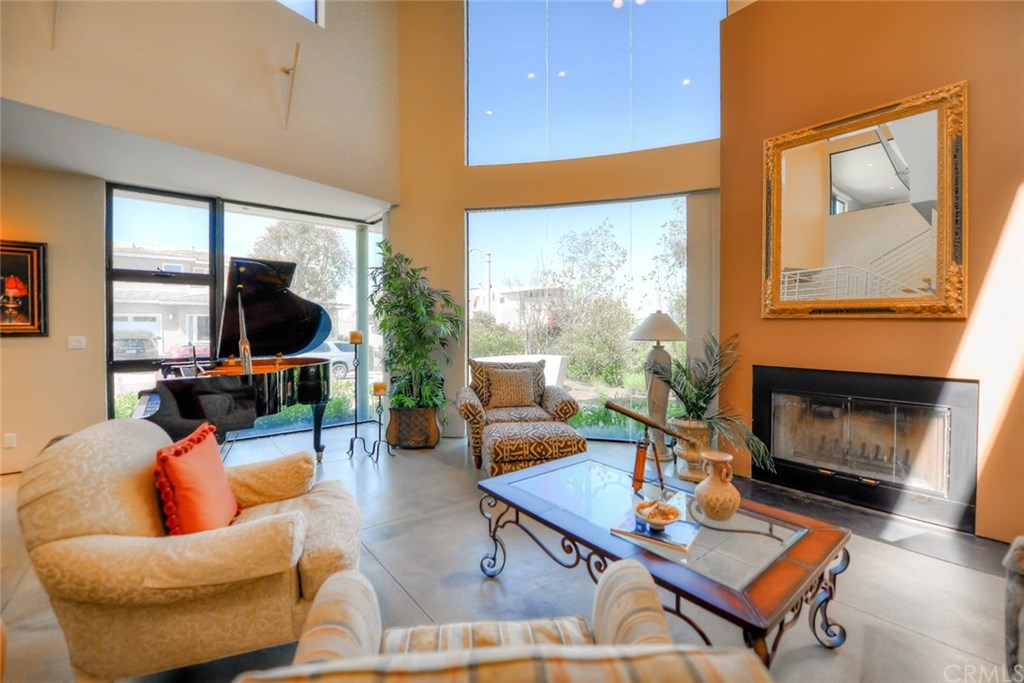 2831 Ridge Drive Laguna Beach, CA 92651 - Photo 4 of 49 a living room with furniture a flat screen tv and a fireplace