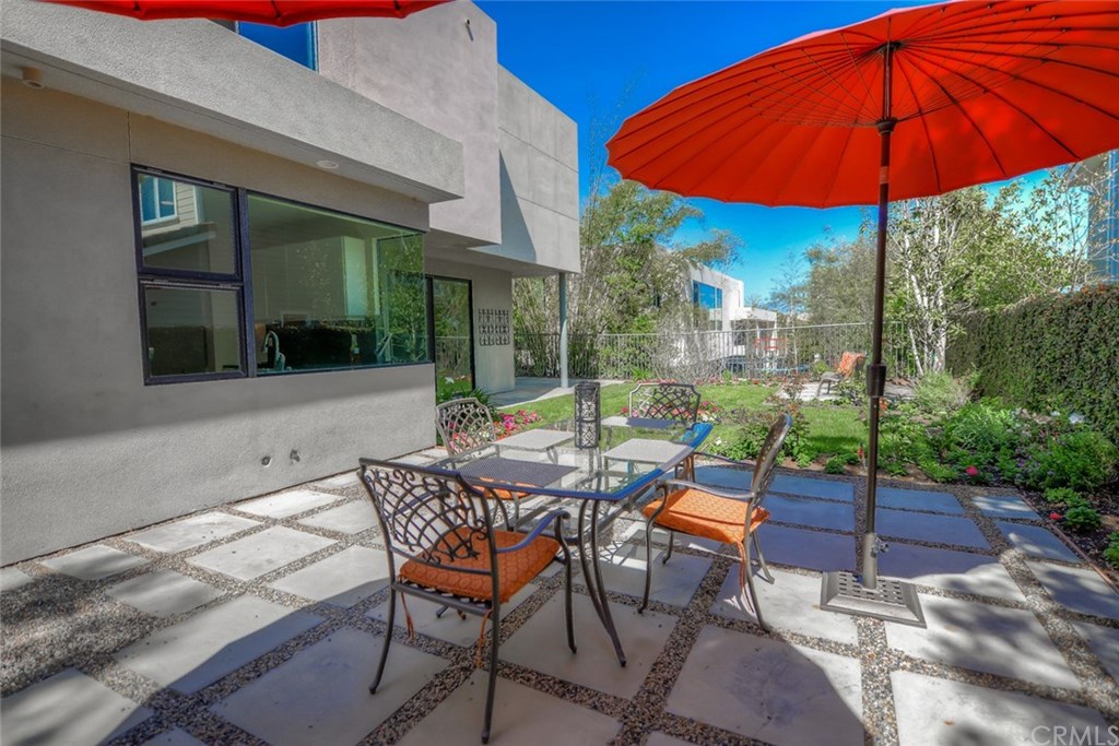 2831 Ridge Drive Laguna Beach, CA 92651 - Photo 44 of 49 a patio with a table and chairs under an umbrella