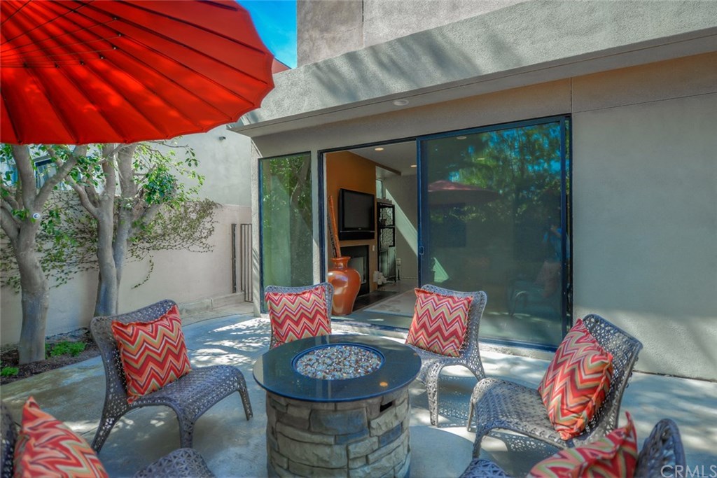 2831 Ridge Drive Laguna Beach, CA 92651 - Photo 46 of 49 a patio with a table and chairs under an umbrella