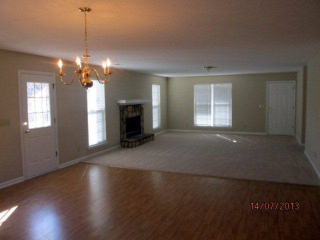 437 Comer Road Gray, GA 31032 - Photo 9 of 20 a view of a livingroom with a fireplace window and wooden floor