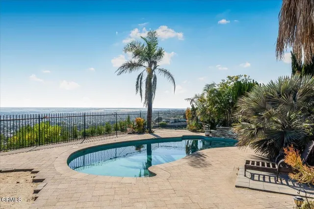 a view of a swimming pool with a table and chairs