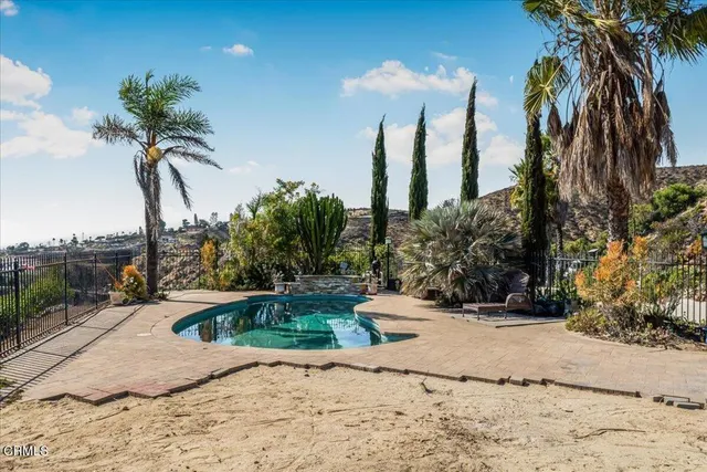 a view of a swimming pool with a yard