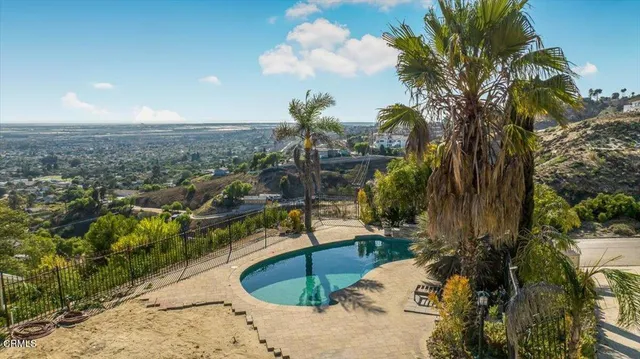 a view of a swimming pool with a patio