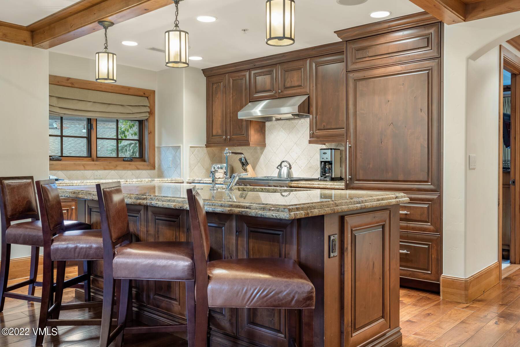 74 Willow Road, Unit 401D Vail, CO 81657 - Photo 3 of 29 a kitchen with a sink stove and chairs