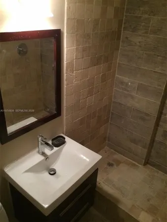 a kitchen with granite countertop white cabinets and stainless steel appliances