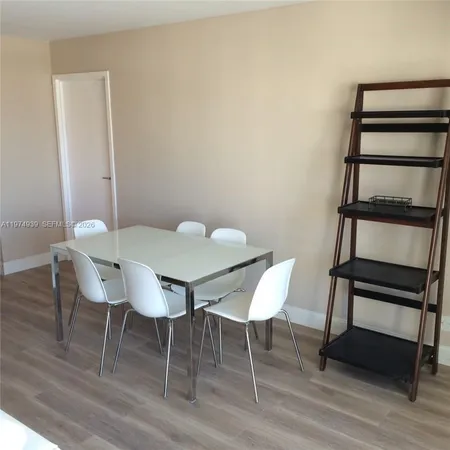a view of a room with furniture and wooden floor