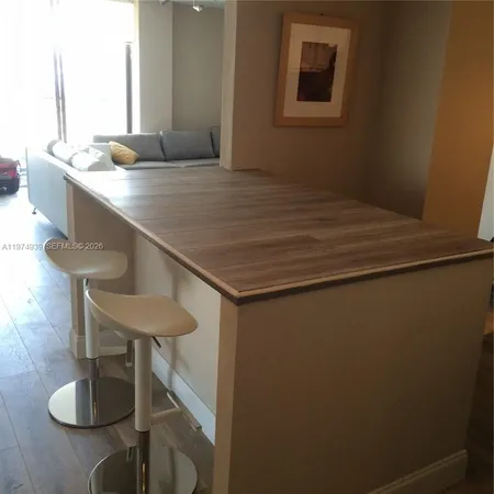 a kitchen with a sink cabinets and window