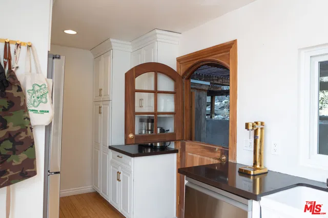 a hallway with sliding door and wooden floor