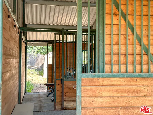 a view of porch with a table and chairs