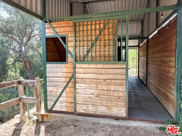 a view of a patio with couches and a fire pit and a large tree
