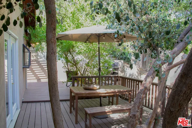a view of a balcony with table and chairs