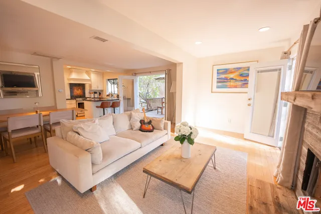 a living room with furniture large window and a flat screen tv