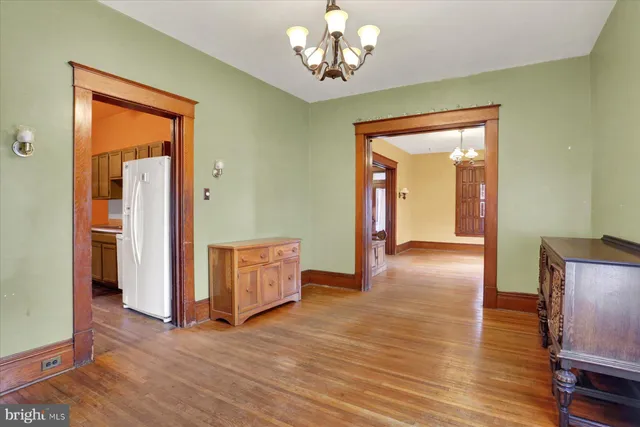 a view of a livingroom with wooden floor and entryway