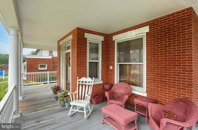 a view of a deck with table and chairs and wooden floor