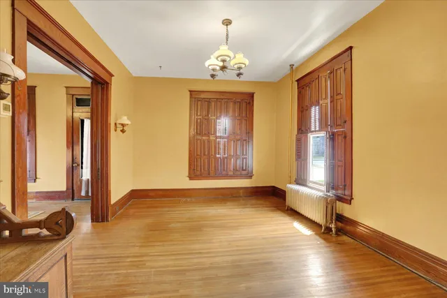 a view of an entryway with wooden floor and door