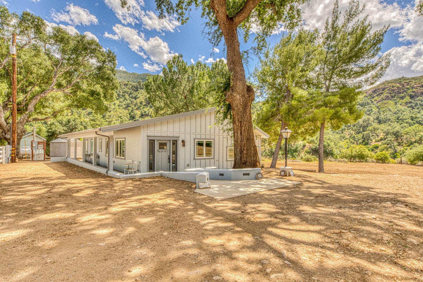 47317 Arroyo Seco Road Greenfield, CA 93927 - Photo 3 of 47 a front view of a house with a garden and trees