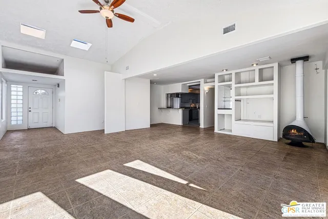 a view of a livingroom with a ceiling fan and window