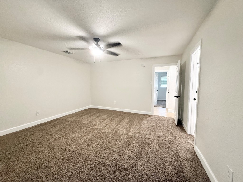 1429 Northview Drive Angleton, TX 77515 - Photo 13 of 29 an empty room with fan and a ceiling fan