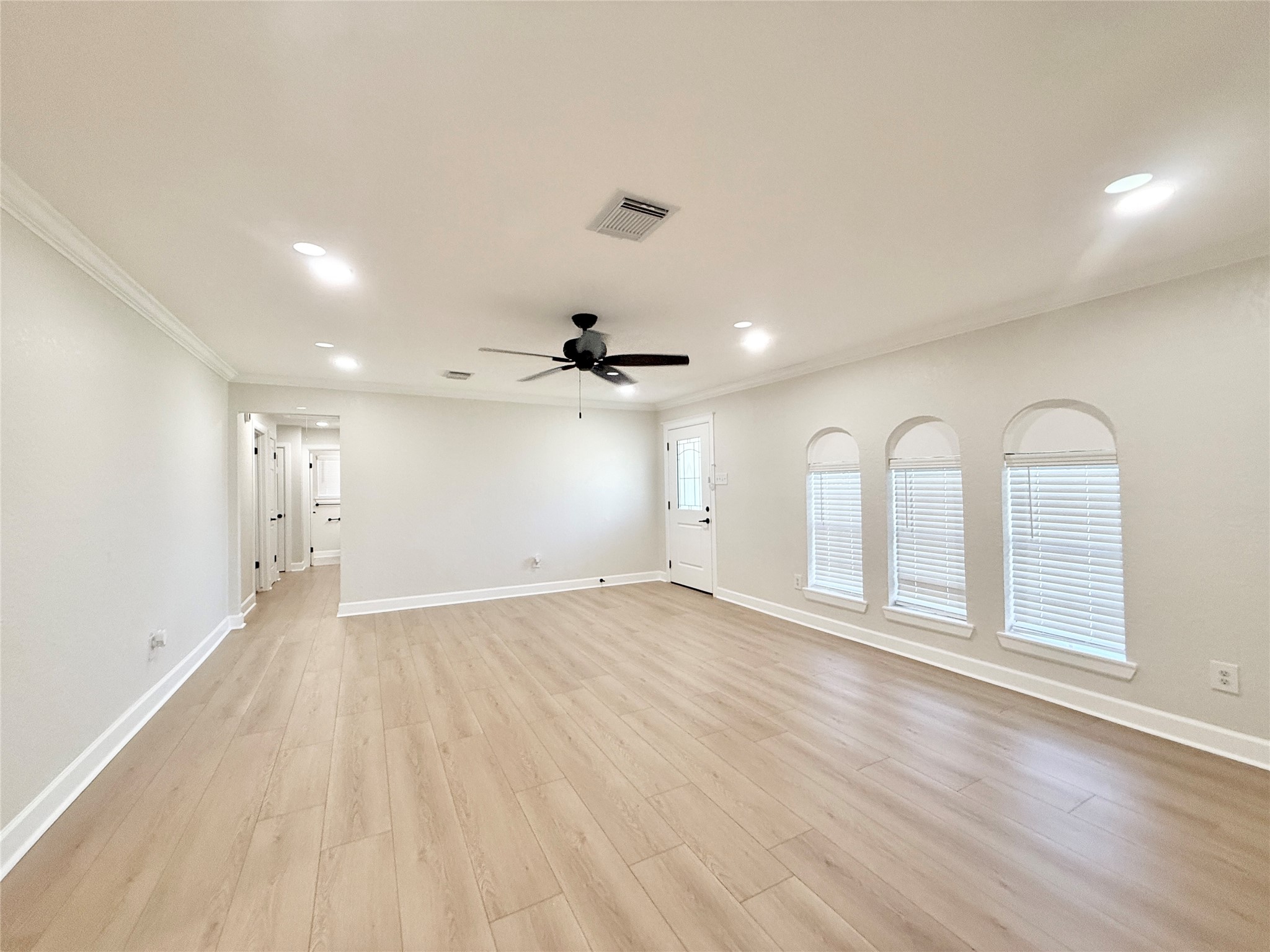 1429 Northview Drive Angleton, TX 77515 - Photo 2 of 29 an empty room with wooden floor and windows