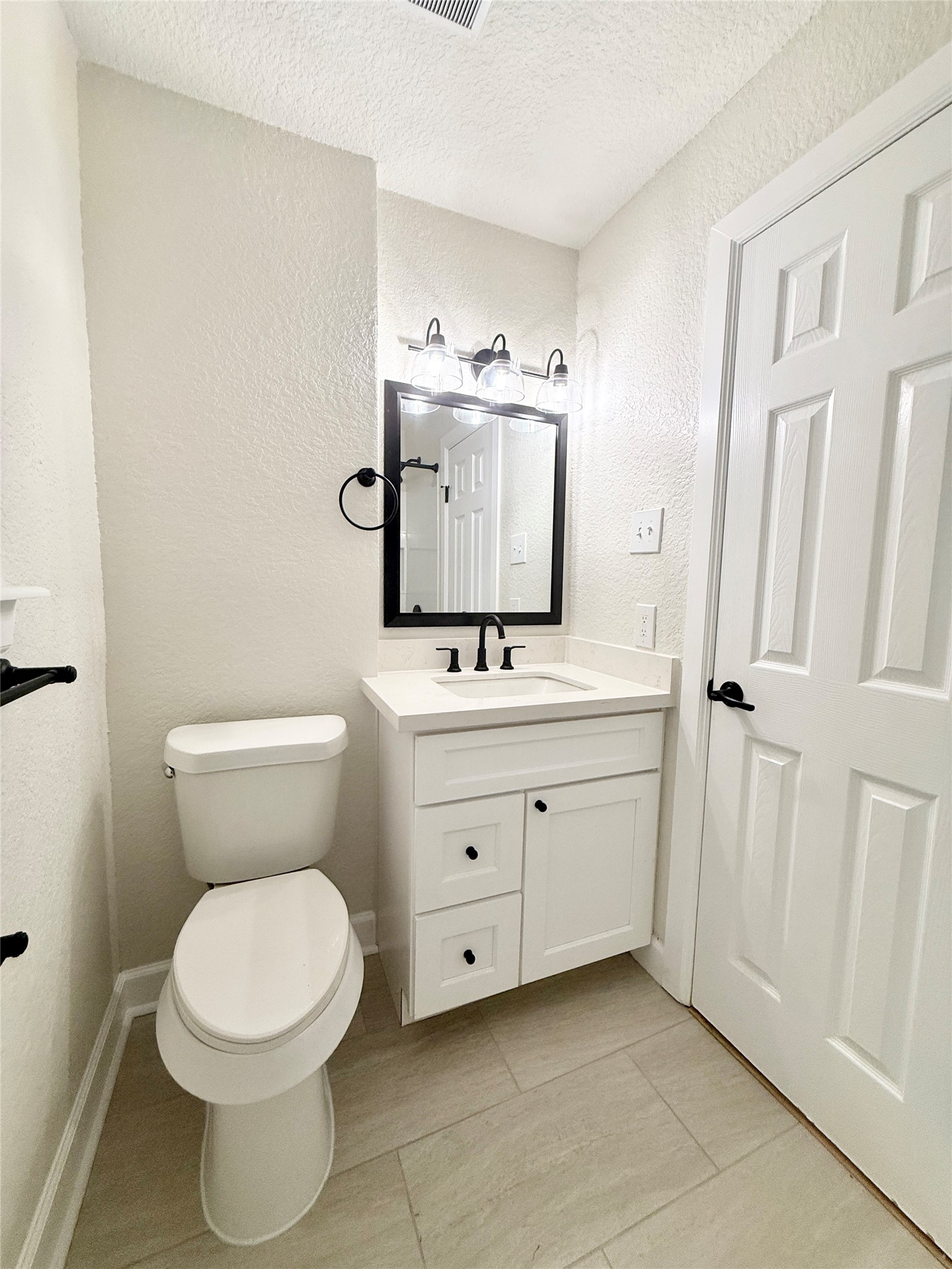 1429 Northview Drive Angleton, TX 77515 - Photo 23 of 29 a bathroom with a toilet sink and mirror