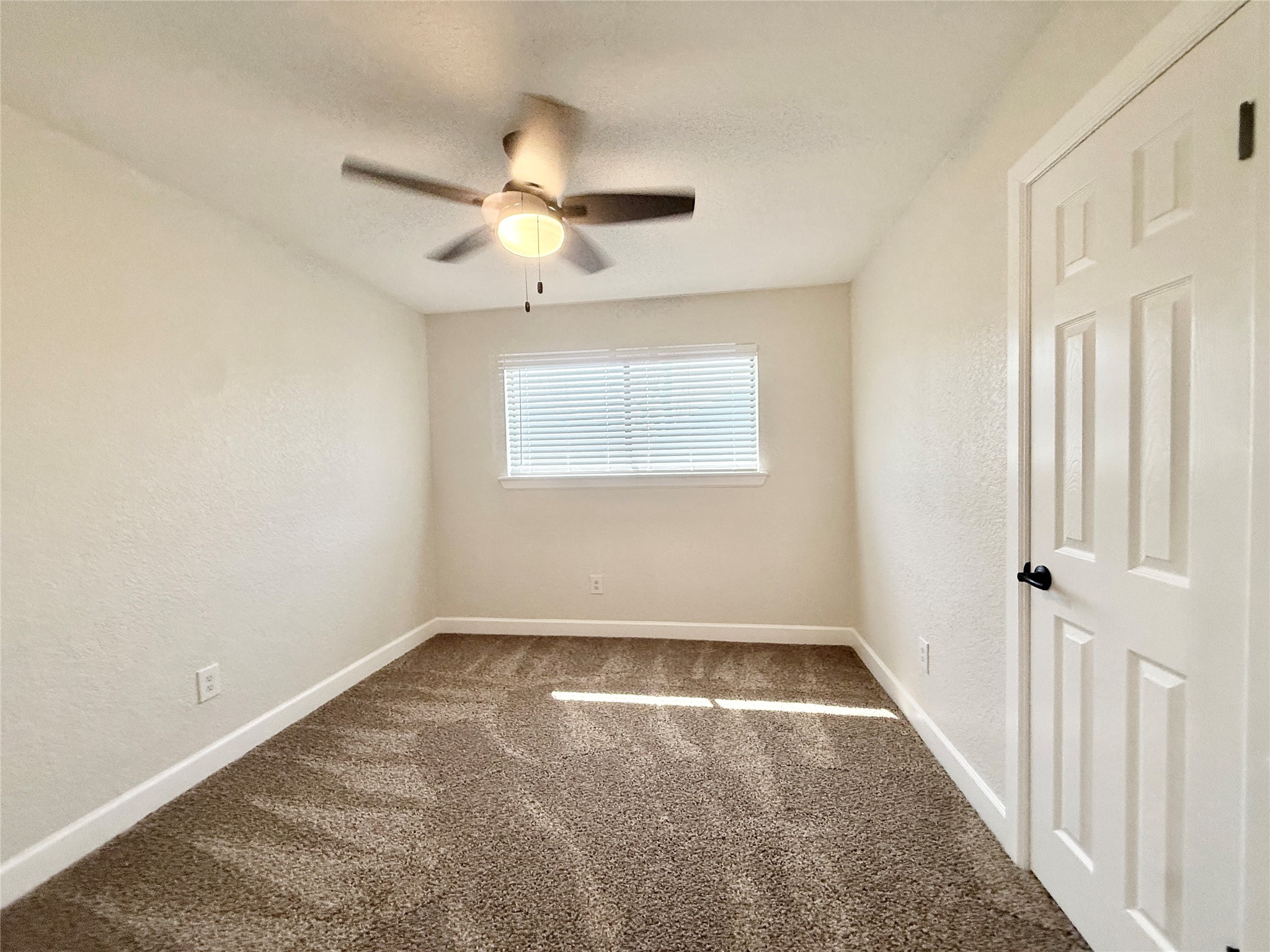 1429 Northview Drive Angleton, TX 77515 - Photo 26 of 29 an empty room with windows and fan