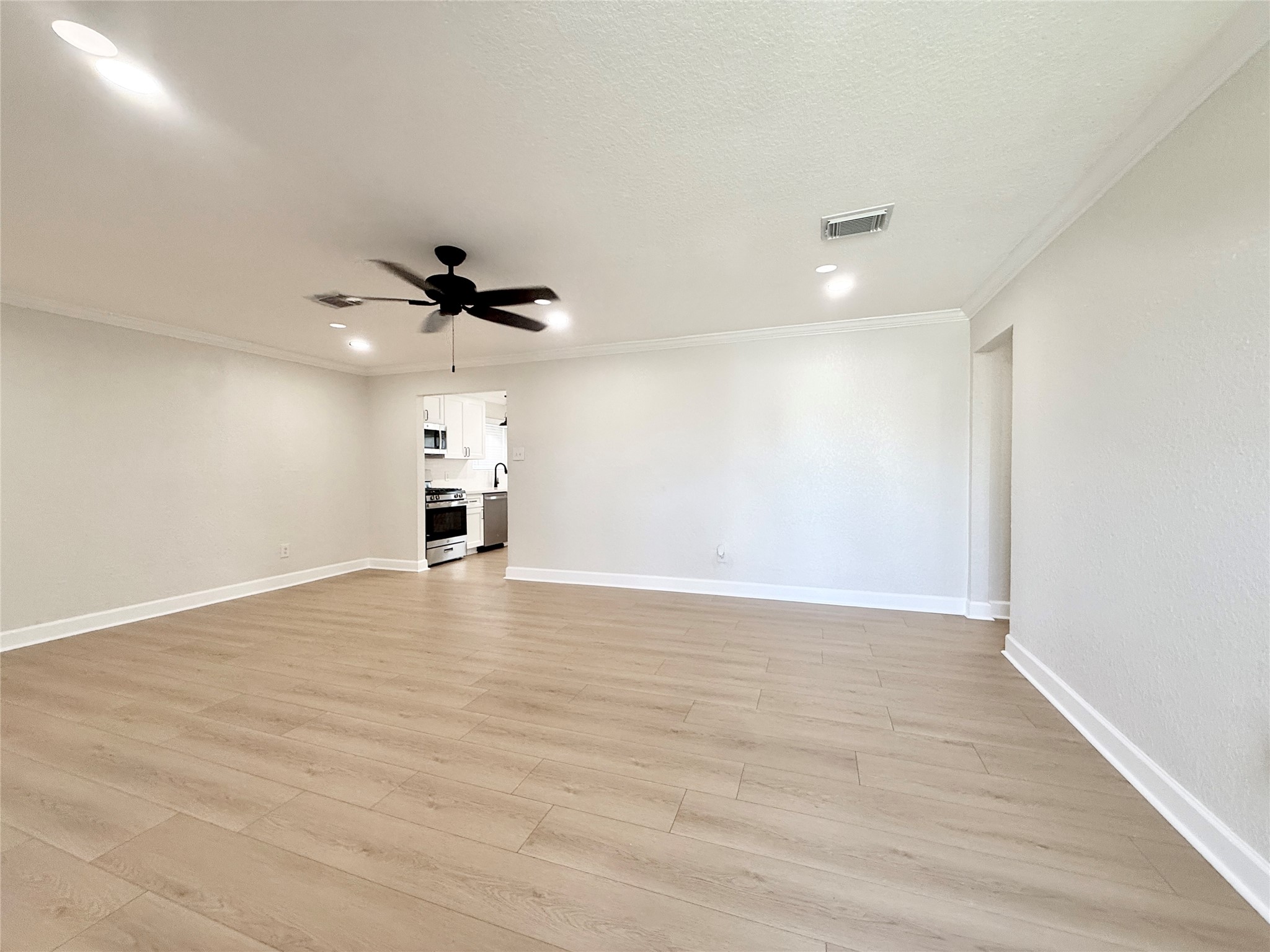 1429 Northview Drive Angleton, TX 77515 - Photo 4 of 29 a view of empty room with wooden floor and fan