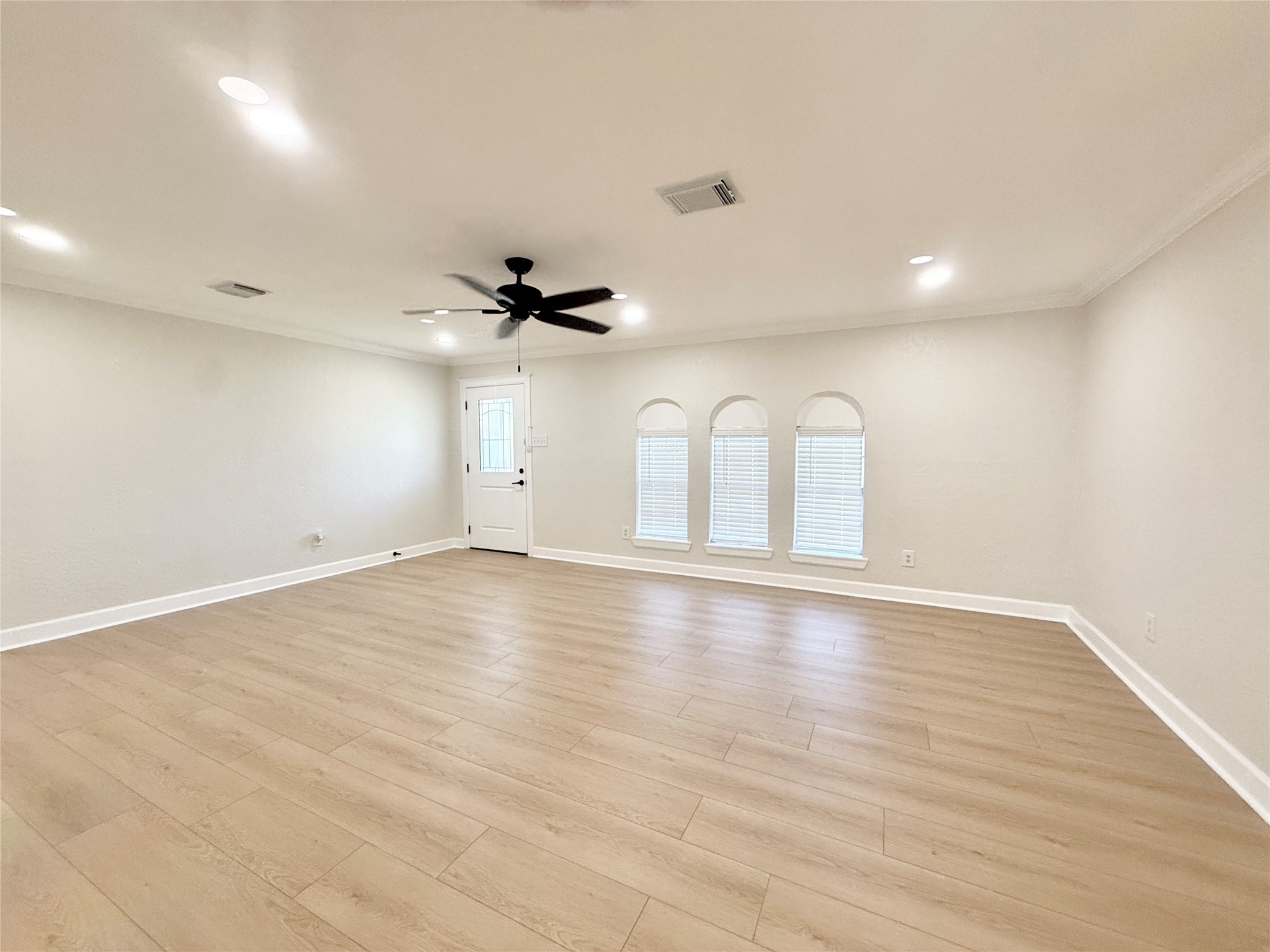 1429 Northview Drive Angleton, TX 77515 - Photo 5 of 29 an empty room with wooden floor and windows