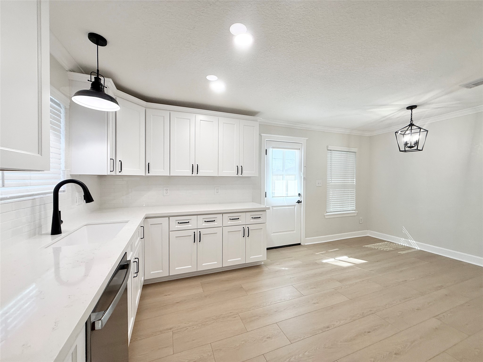 1429 Northview Drive Angleton, TX 77515 - Photo 6 of 29 a kitchen with granite countertop white cabinets and white appliances