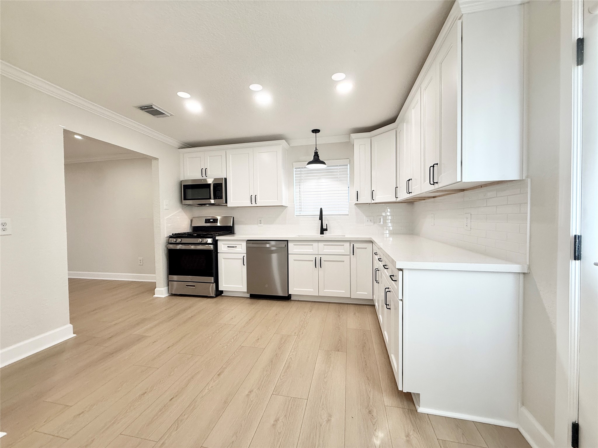 1429 Northview Drive Angleton, TX 77515 - Photo 7 of 29 a kitchen with white cabinets and white appliances