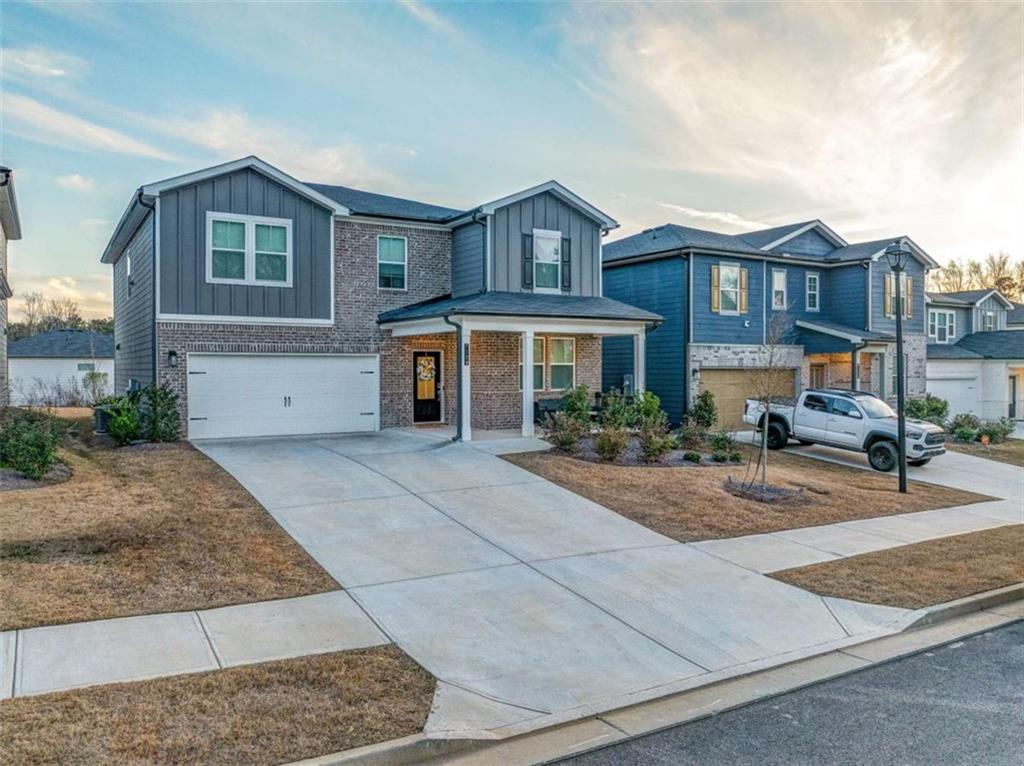 7129 Timberland Trail Lithonia, GA 30058 - Photo 1 of 43 a front view of a house with yard and parking