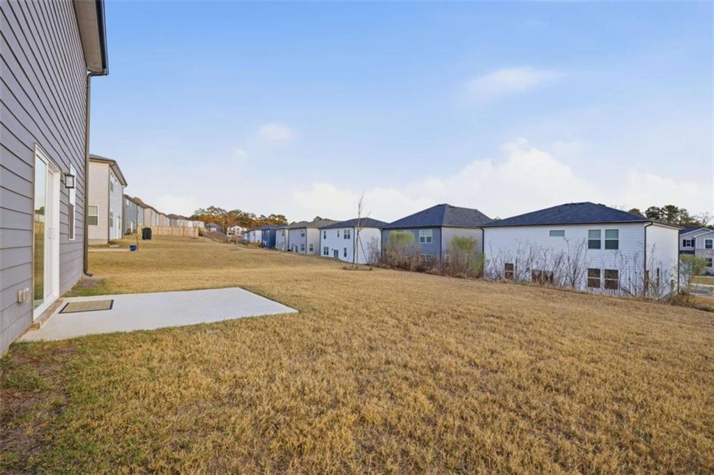 7129 Timberland Trail Lithonia, GA 30058 - Photo 11 of 43 a view of an house with backyard and tall trees