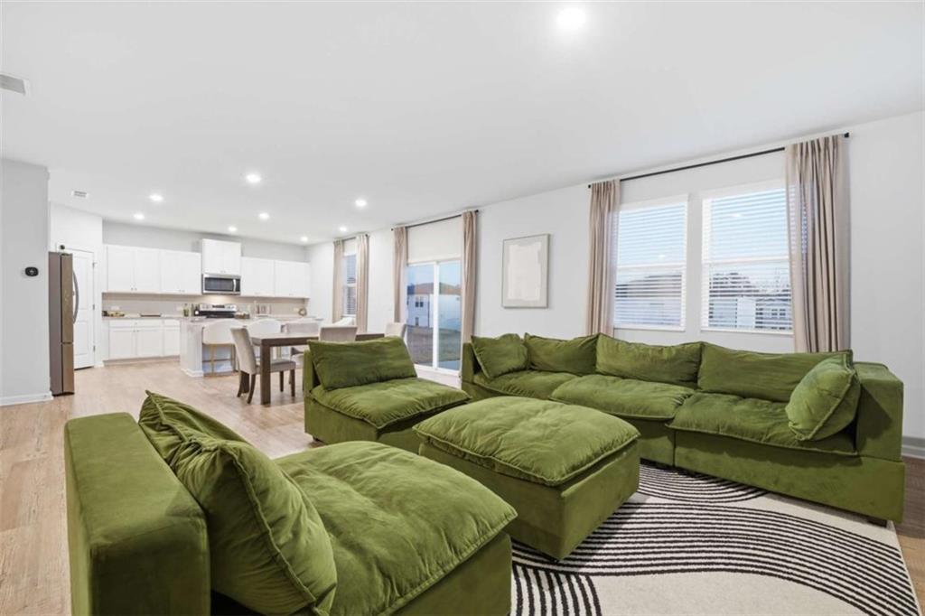7129 Timberland Trail Lithonia, GA 30058 - Photo 12 of 43 a living room with furniture and a large window