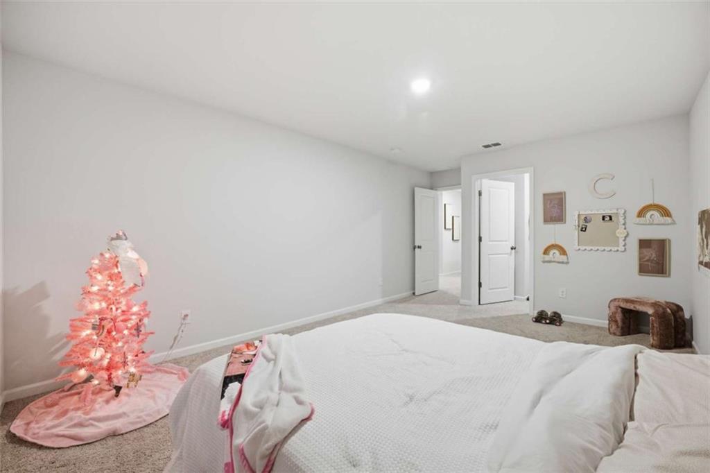 7129 Timberland Trail Lithonia, GA 30058 - Photo 15 of 43 a bedroom with a bed and a chair