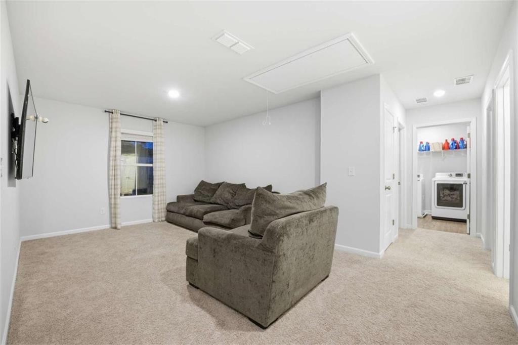 7129 Timberland Trail Lithonia, GA 30058 - Photo 16 of 43 a living room with furniture and a fireplace