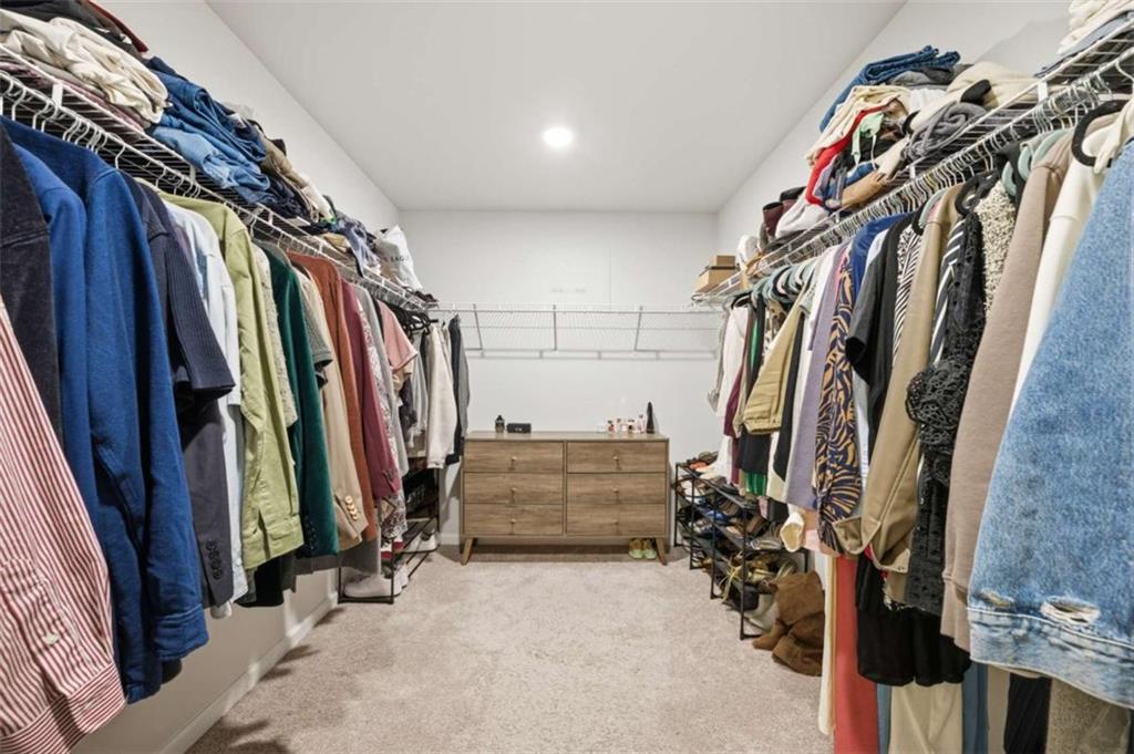 7129 Timberland Trail Lithonia, GA 30058 - Photo 19 of 43 a view of walk in closet with clothes