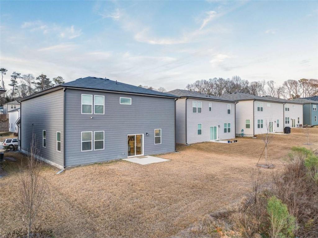 7129 Timberland Trail Lithonia, GA 30058 - Photo 2 of 43 a front view of a house with a yard and garage