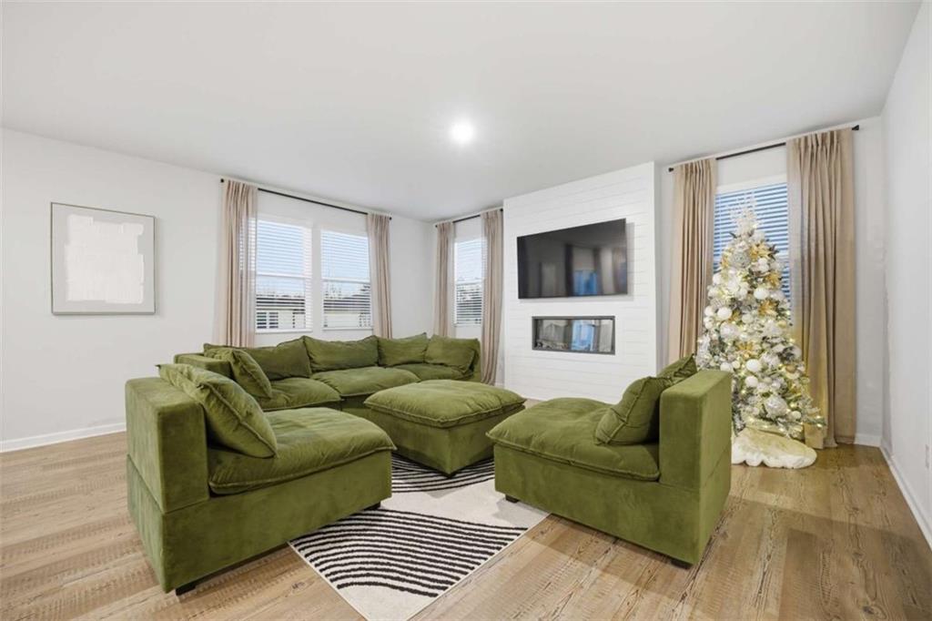 7129 Timberland Trail Lithonia, GA 30058 - Photo 24 of 43 a living room with furniture and a flat screen tv