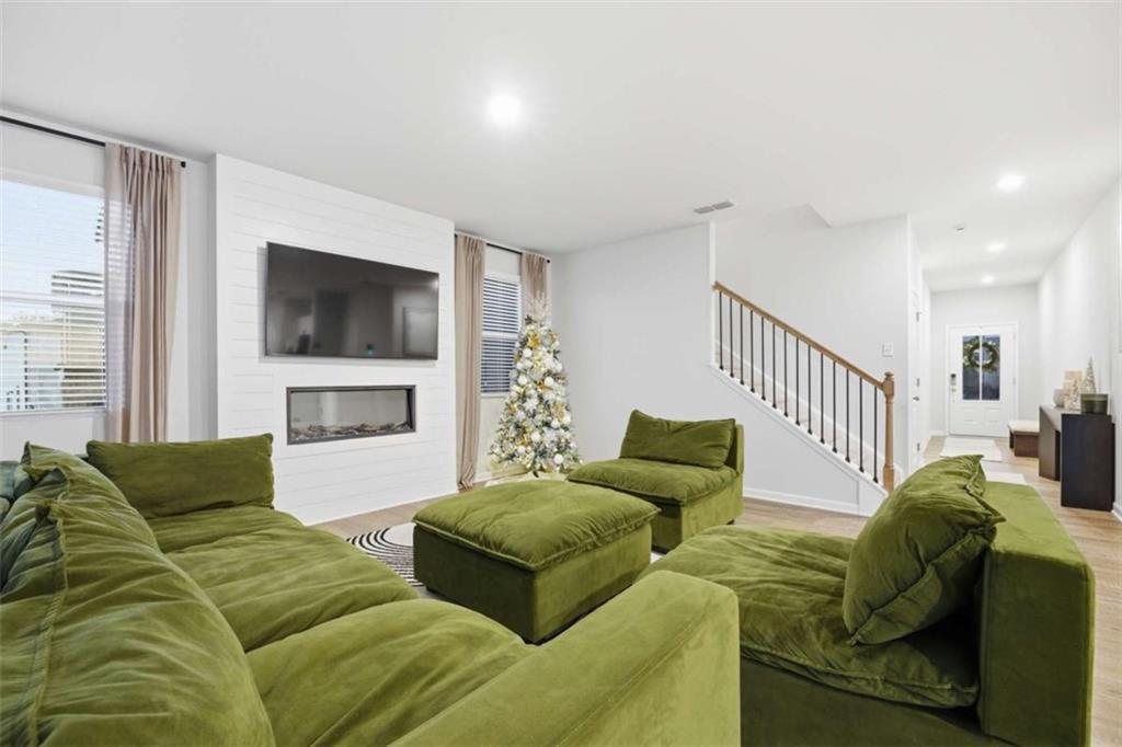 7129 Timberland Trail Lithonia, GA 30058 - Photo 25 of 43 a living room with furniture and a flat screen tv