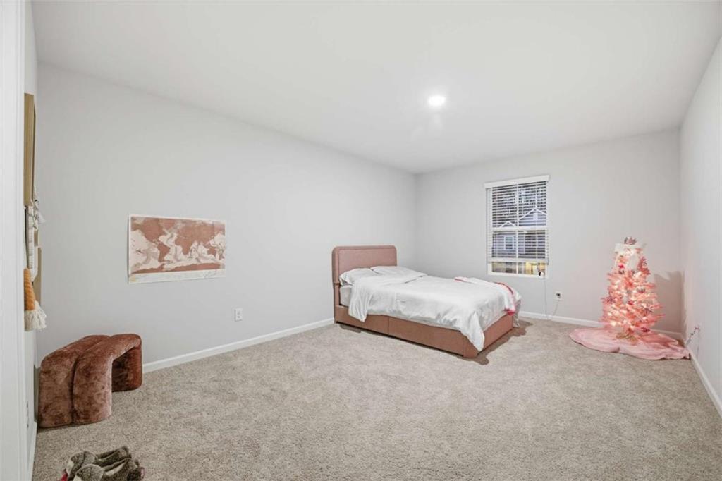 7129 Timberland Trail Lithonia, GA 30058 - Photo 30 of 43 a bedroom with a bed and a chair