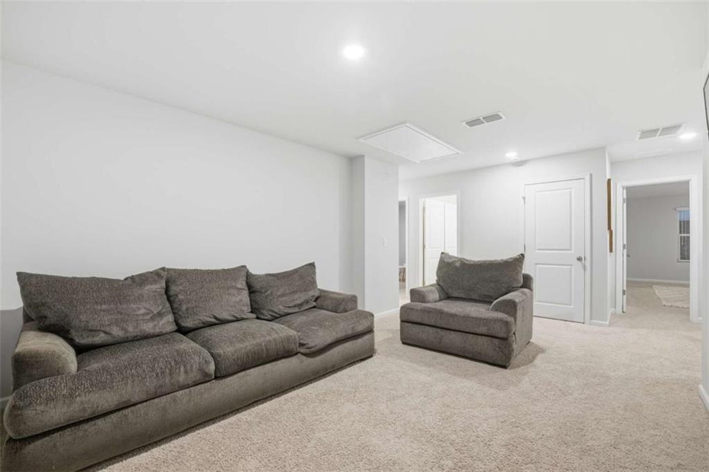 7129 Timberland Trail Lithonia, GA 30058 - Photo 35 of 43 a living room with furniture and a couch