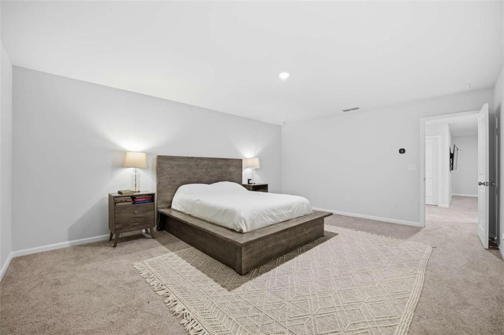 7129 Timberland Trail Lithonia, GA 30058 - Photo 36 of 43 a bedroom with a bed and lamp