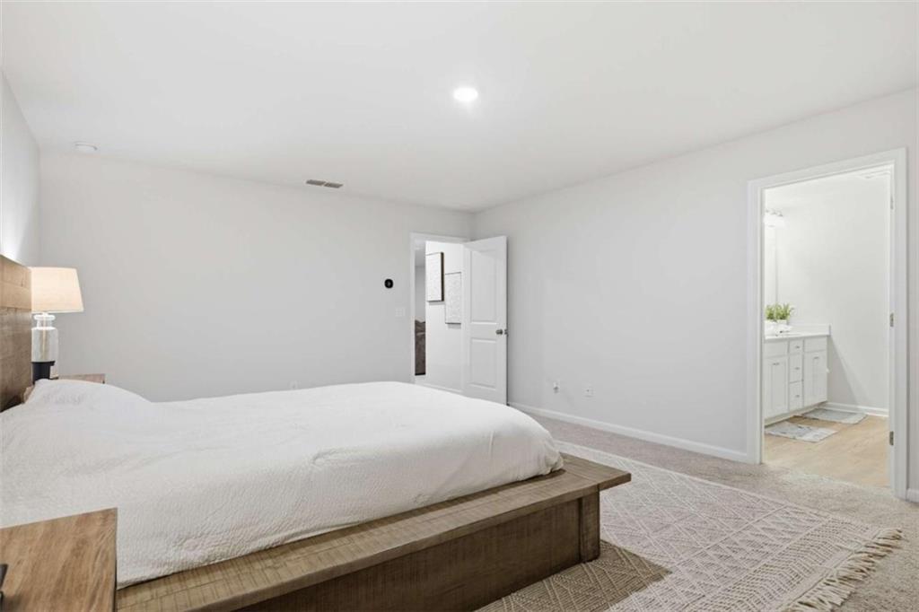 7129 Timberland Trail Lithonia, GA 30058 - Photo 37 of 43 a bedroom with a bed and a toilet