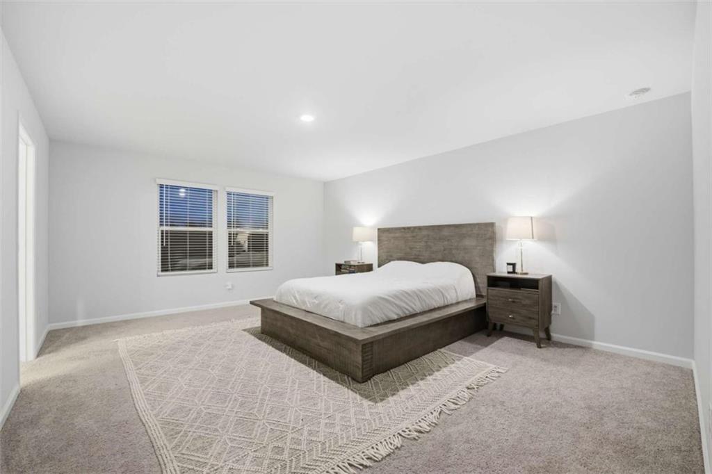 7129 Timberland Trail Lithonia, GA 30058 - Photo 38 of 43 a bedroom with a bed lamp closet and a large window