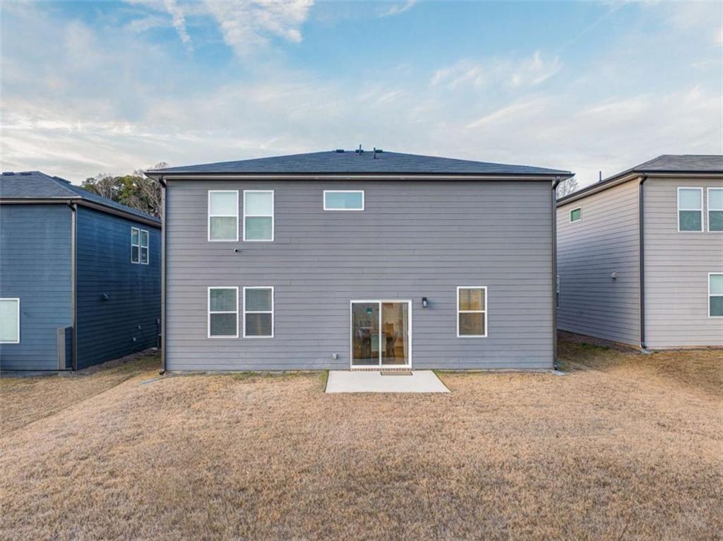 7129 Timberland Trail Lithonia, GA 30058 - Photo 5 of 43 a front view of a house with a yard