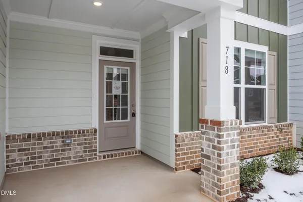 a kitchen with kitchen island white cabinets and wooden floor