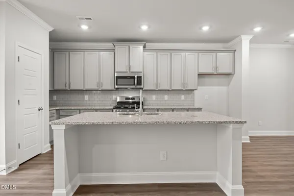a kitchen with stainless steel appliances granite countertop a sink stove and cabinets